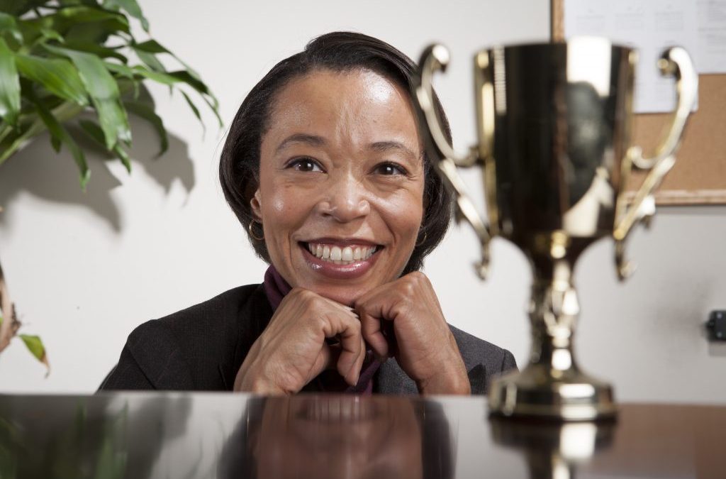 Smiling Business woman with an award on her table